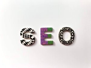 Colorful, patterned magnets that spell out SEO on a white background.
